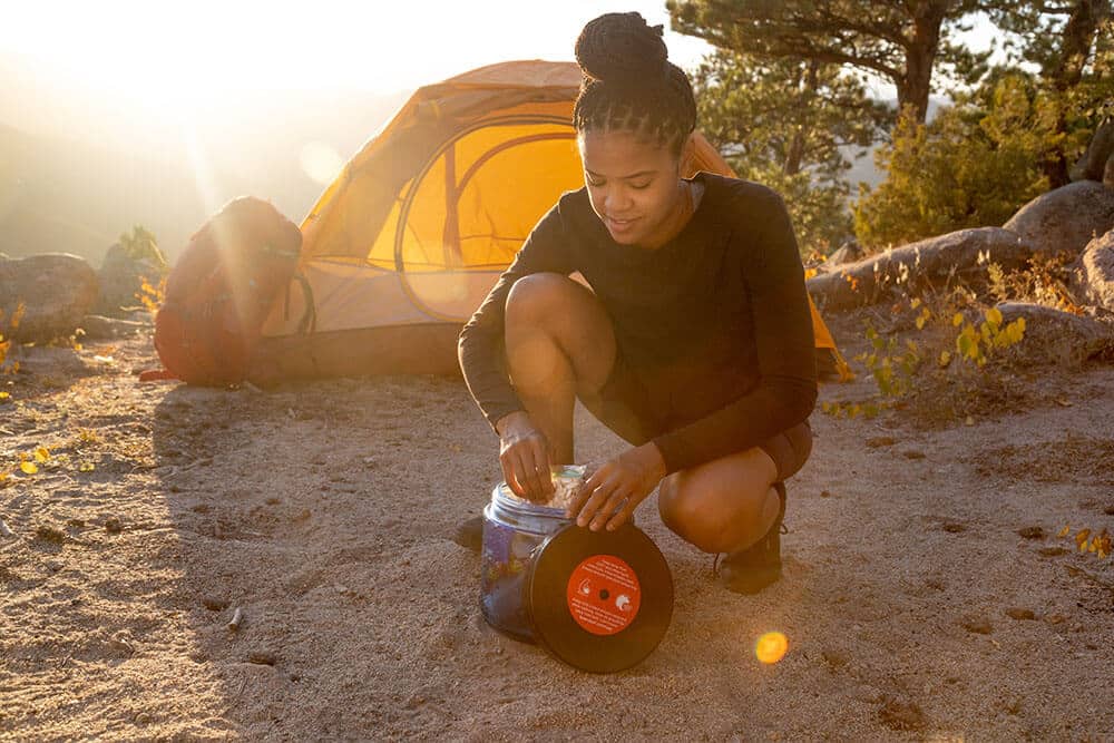 Woman packing a BearVault bear canister