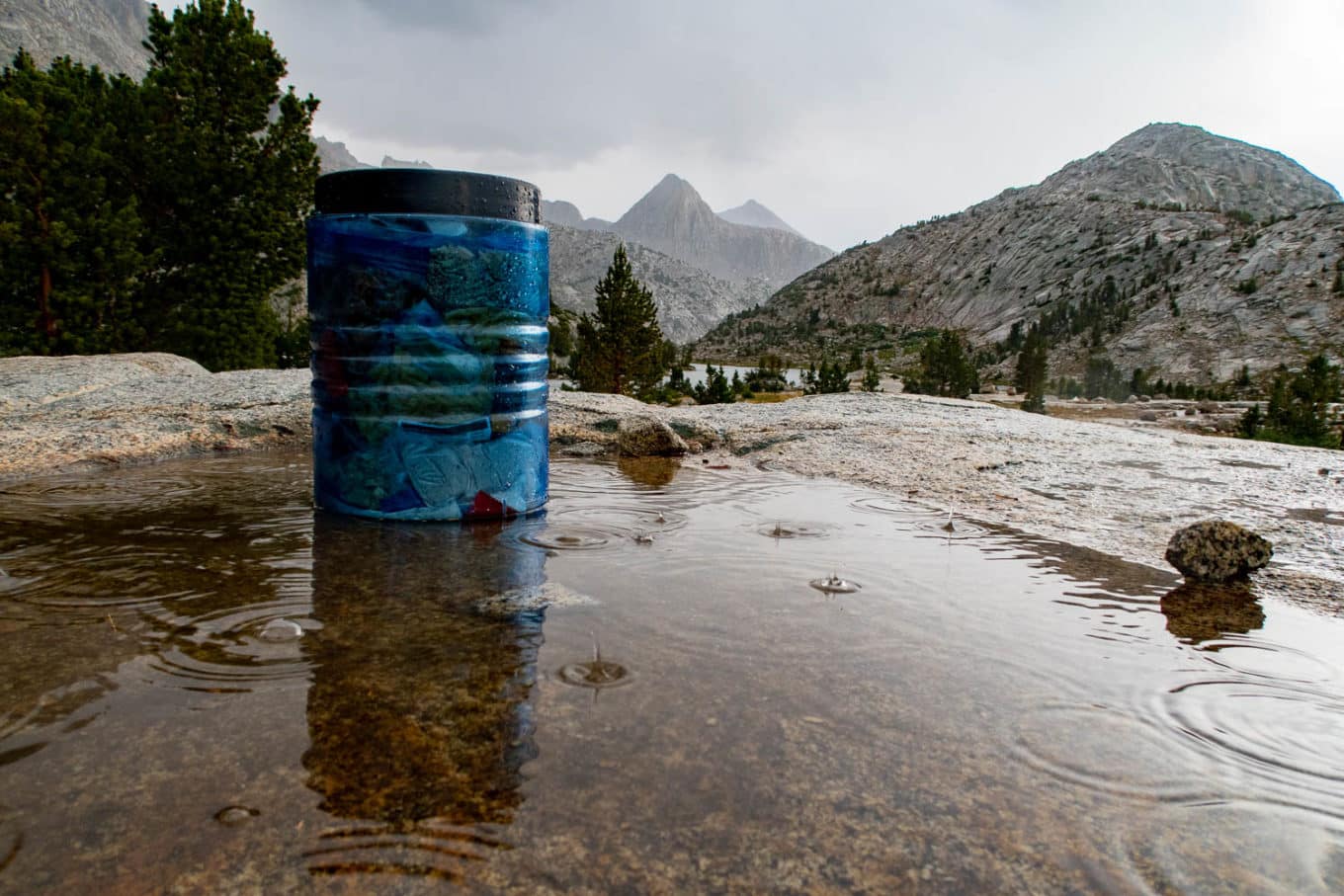 BearVault in pouring rain with mountains in background